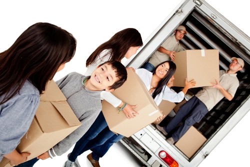 Loading furniture and boxes into a moving truck in Edgware